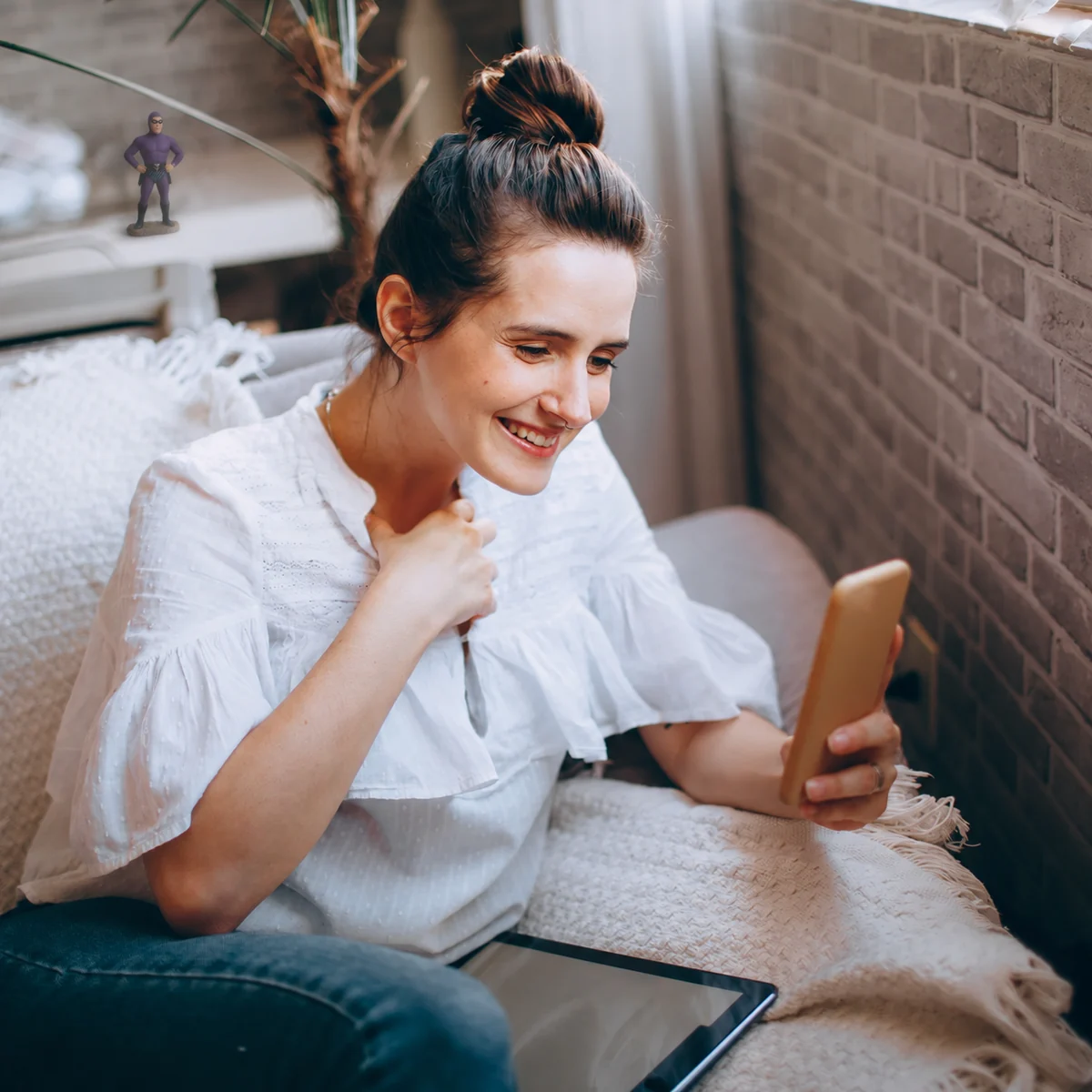 A woman checking her phone at home.