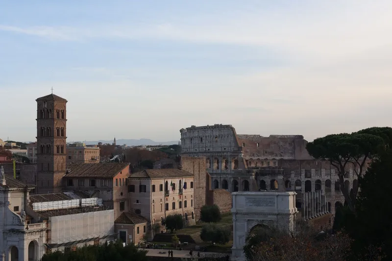 Rome’s historic skyline with the Colosseum in soft evening light.